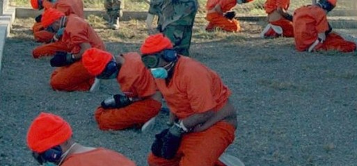 US-Camp_x-ray_detainees-Guantanamo-Bay-Jan-11-2002-Phot-Shane-T-McCoy-US-Navy-Creative-Commons-513x239[1]